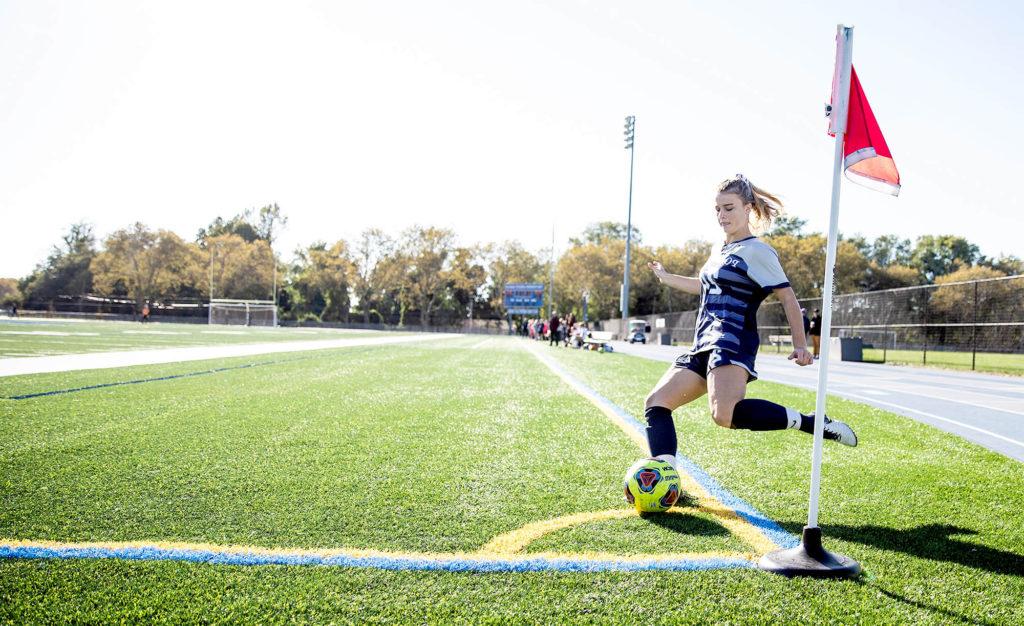 Girls' soccer star Sydney Urban kicking a corner